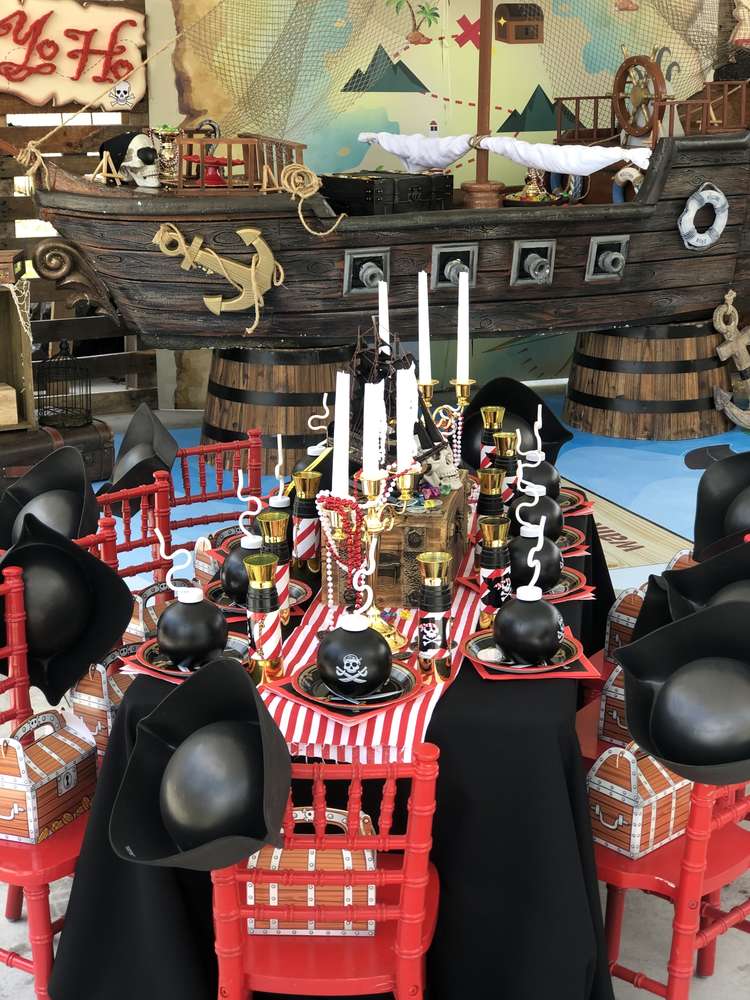 Lavish pirate table settings with a treasure chest centerpiece