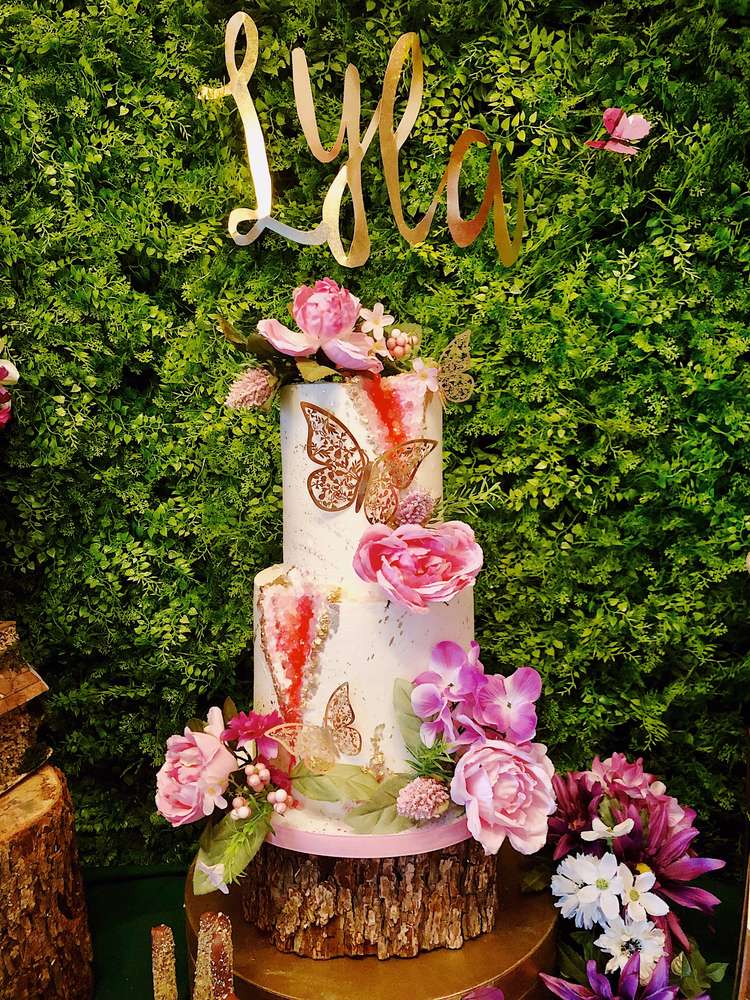 Enchanting birthday cake decorated with fresh flowers and butterflies