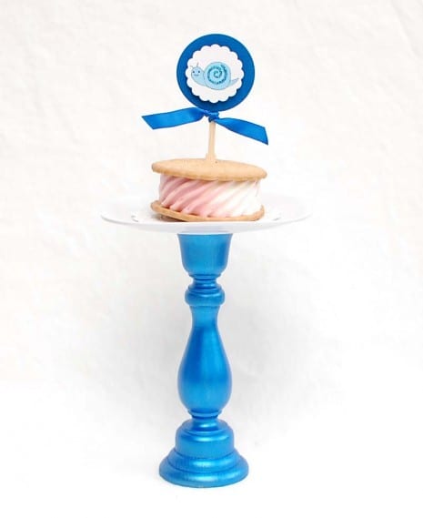 A melamine plate with a doily and an ice cream sandwich
