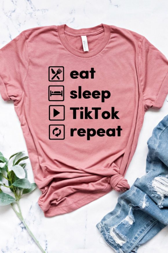 TikTok Party Supplies - 'Eat, Sleep, TikTok, Repeat' T-Shirt | CatchMyParty.com TikTok Party Supplies - 'Eat, Sleep, TikTok, Repeat' T-Shirt